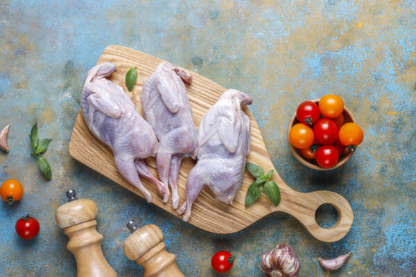 Homemade eco-friendly raw quails ready for cooking. Caille
